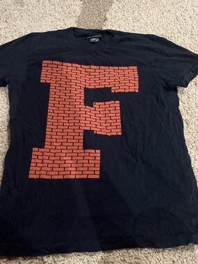 French Connection Black Tee with Brick-Pattern Red 'F' Graphic
